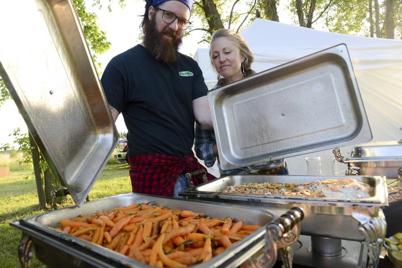 Blue Water Grill owners Josh and Jessica Wiggins show off the Ya Ya glazed carrots grown by Josh Nash.